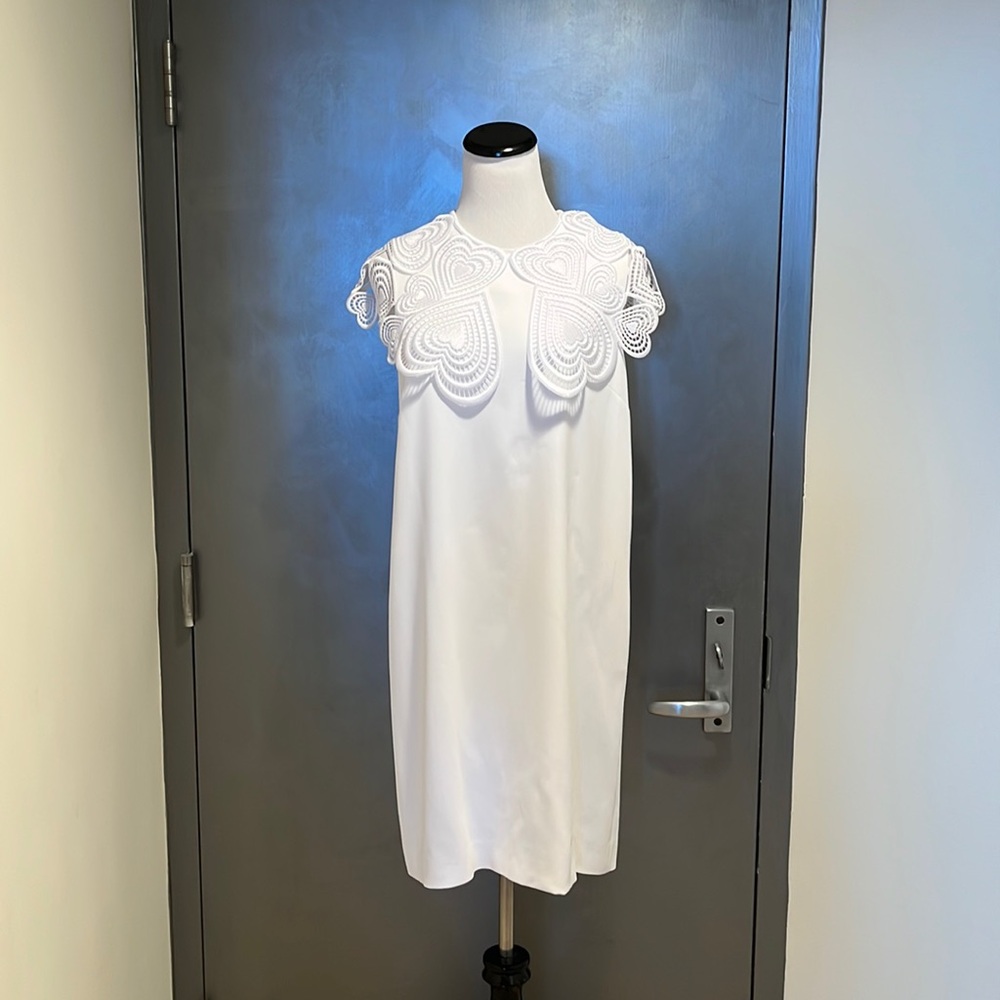 Woman’s dress is Christopher Kane size 10 white
